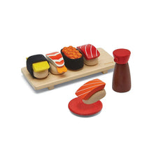 Wooden toy sushi set with a wooden board and salt shaker on a white background