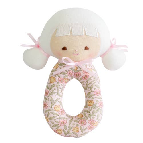 A beige and pink floral-patterned Audrey Grab Rattle with a circular handle and two bumper bumps.