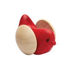 Red and beige wooden bird-shaped object on a white background