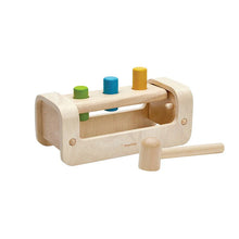 Wooden hammer and block set with colorful blocks on a white background