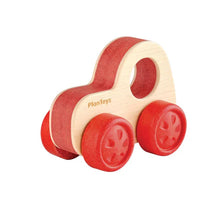 Natural wood vehicle toy with large red wheels