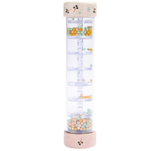 A colorful rain stick toy made by Moulin Roty, featuring small colored beads in a clear tube, designed for children.