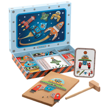 A Space themed hammer tap game set by Djeco, including printed wooden tiles, a wooden mallet, tacks, and inspiration cards, all presented in a wooden box with space-themed artwork.