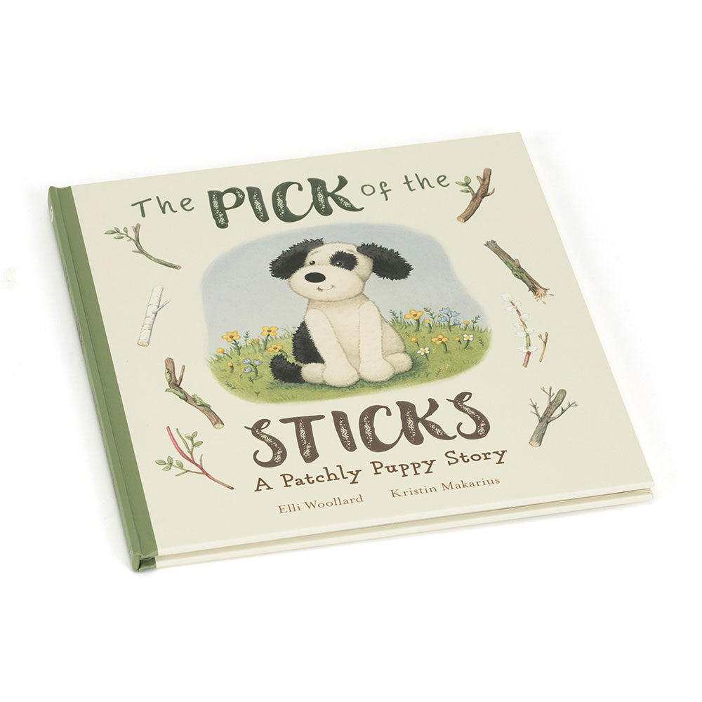 Children's book titled 'The Pick of the Sticks' featuring an illustration of a black and white puppy sitting beside a stick, with a green and beige cover.