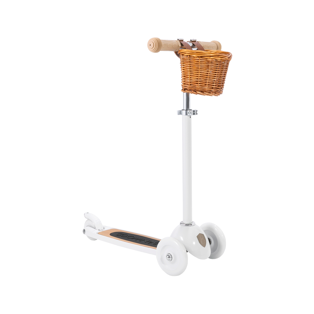 A white three-wheel kick scooter with a brown wicker basket and adjustable handlebar, set against a plain background.