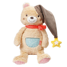 A beige teddy bear with a gray night cap, red scarf, and glow-in-the-dark embroidery, holding a yellow star-shaped night light.