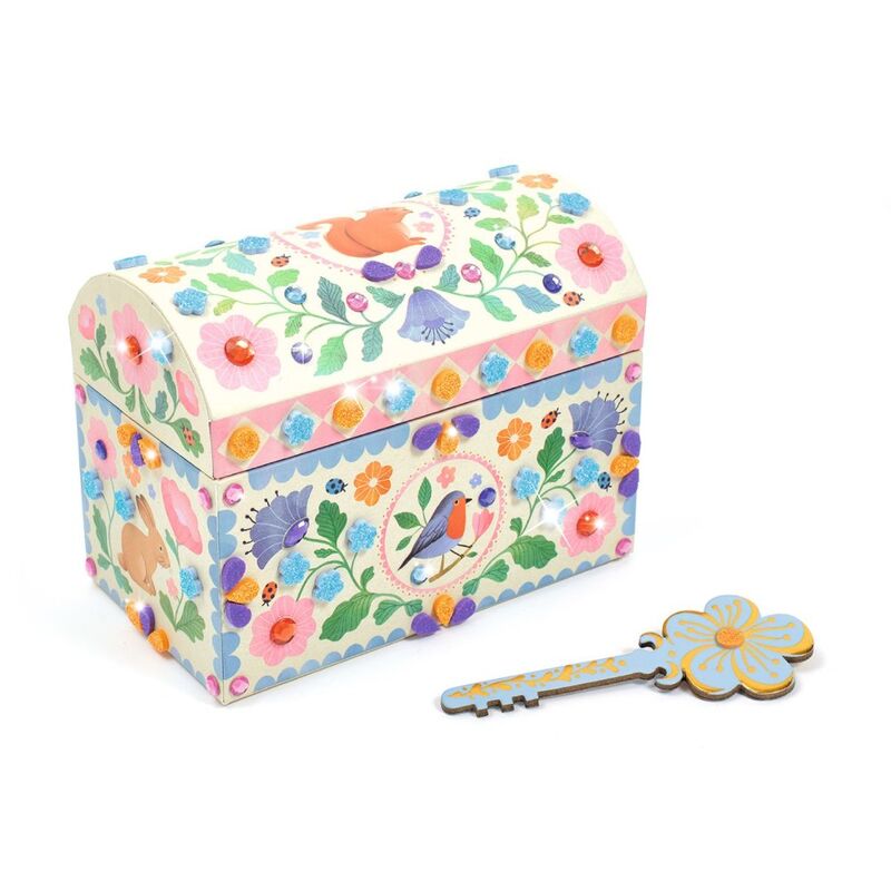 Decorative jewelry box with floral patterns and a matching key on a white background