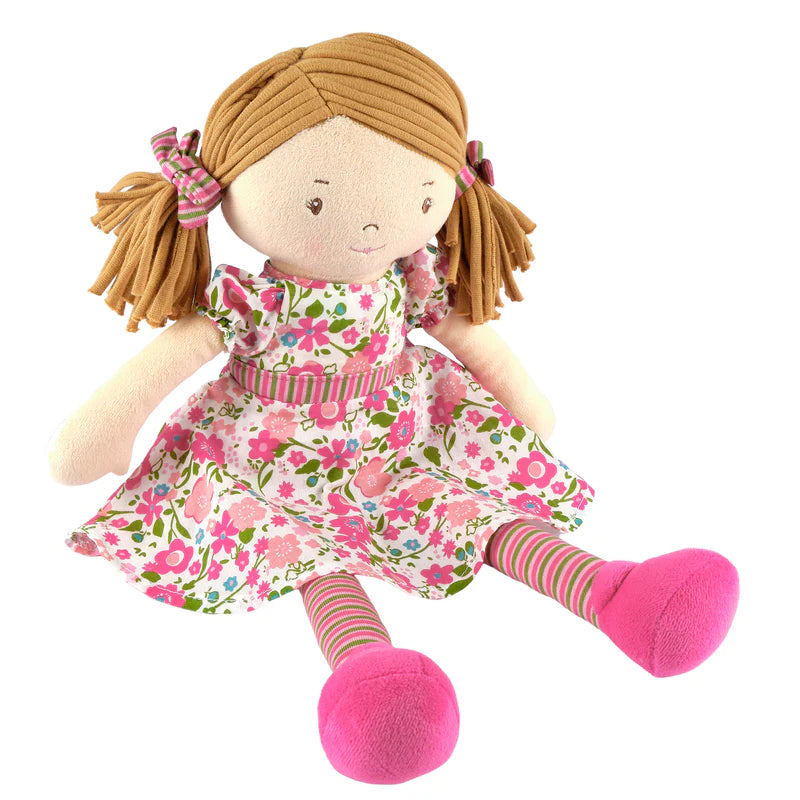 Plush doll with a floral dress and pink shoes on a white background