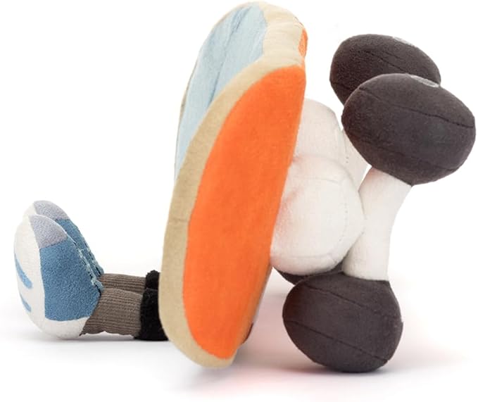 Colorful plush toy with orange foot and black legs on a white background