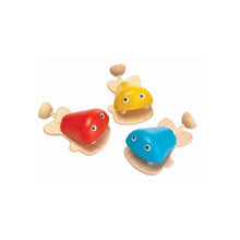 Three colorful wooden toy fish castanets on a white background
