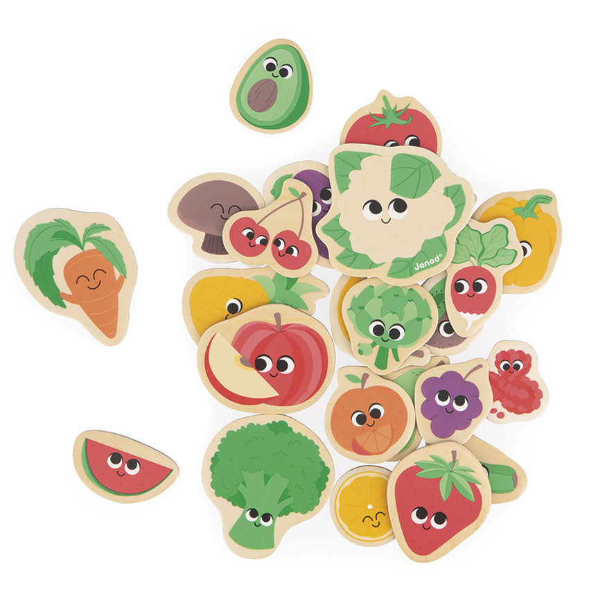 Set of colorful wooden fruit and vegetable magnetic pieces with faces on a white background