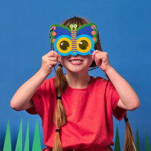 Child wearing a colorful butterfly mask against a blue background