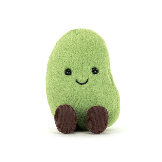Green plush toy resembling a bean with a smiling face and brown legs on a white background