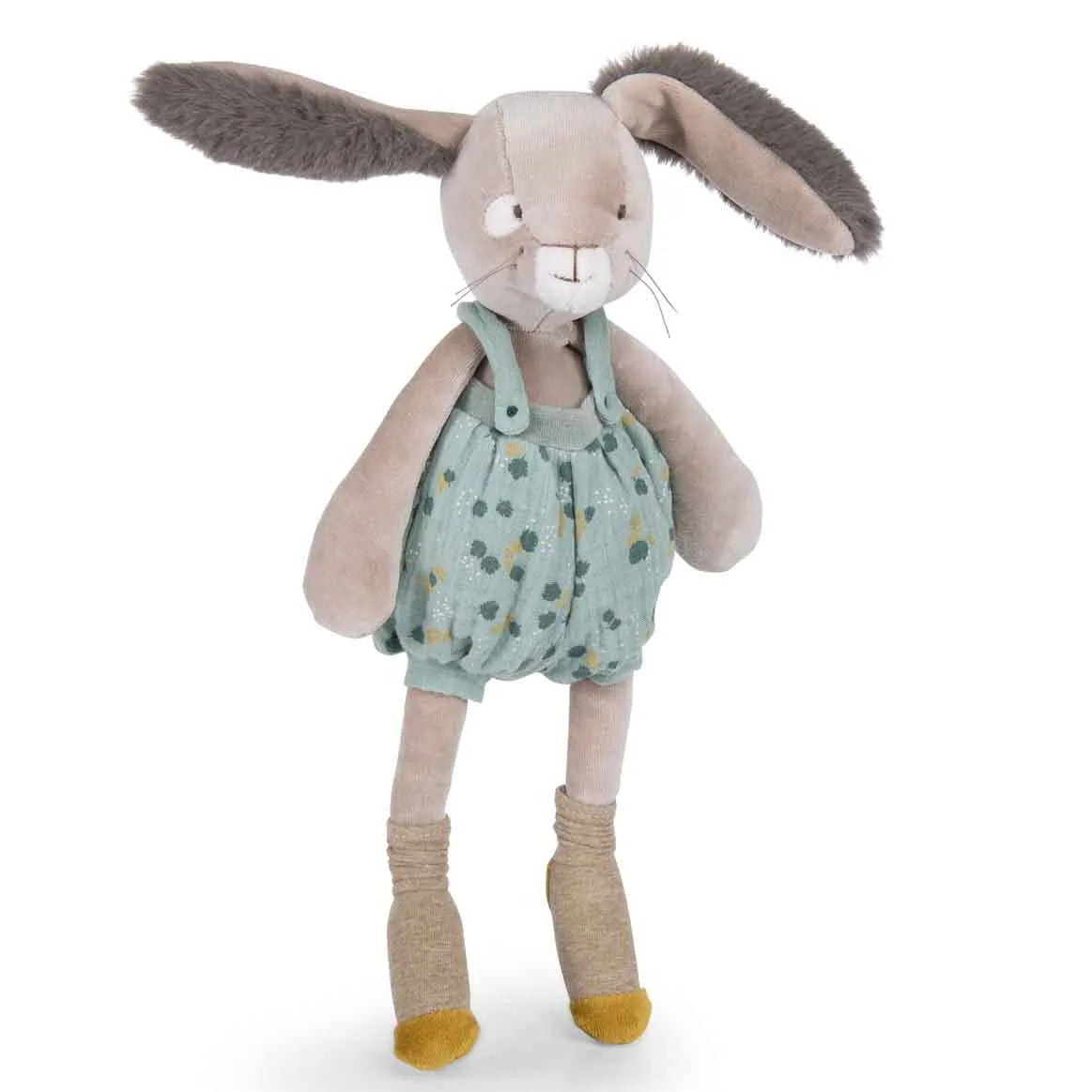 Stuffed bunny toy wearing a green romper with yellow polka dots on a white background