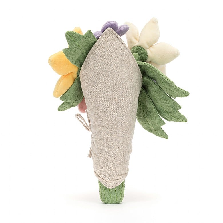 Plush toy resembling a flower with green leaves and a beige center on a white background