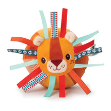 A colorful baby activity toy shaped like a lion with various textures and colorful ribbons attached to it.