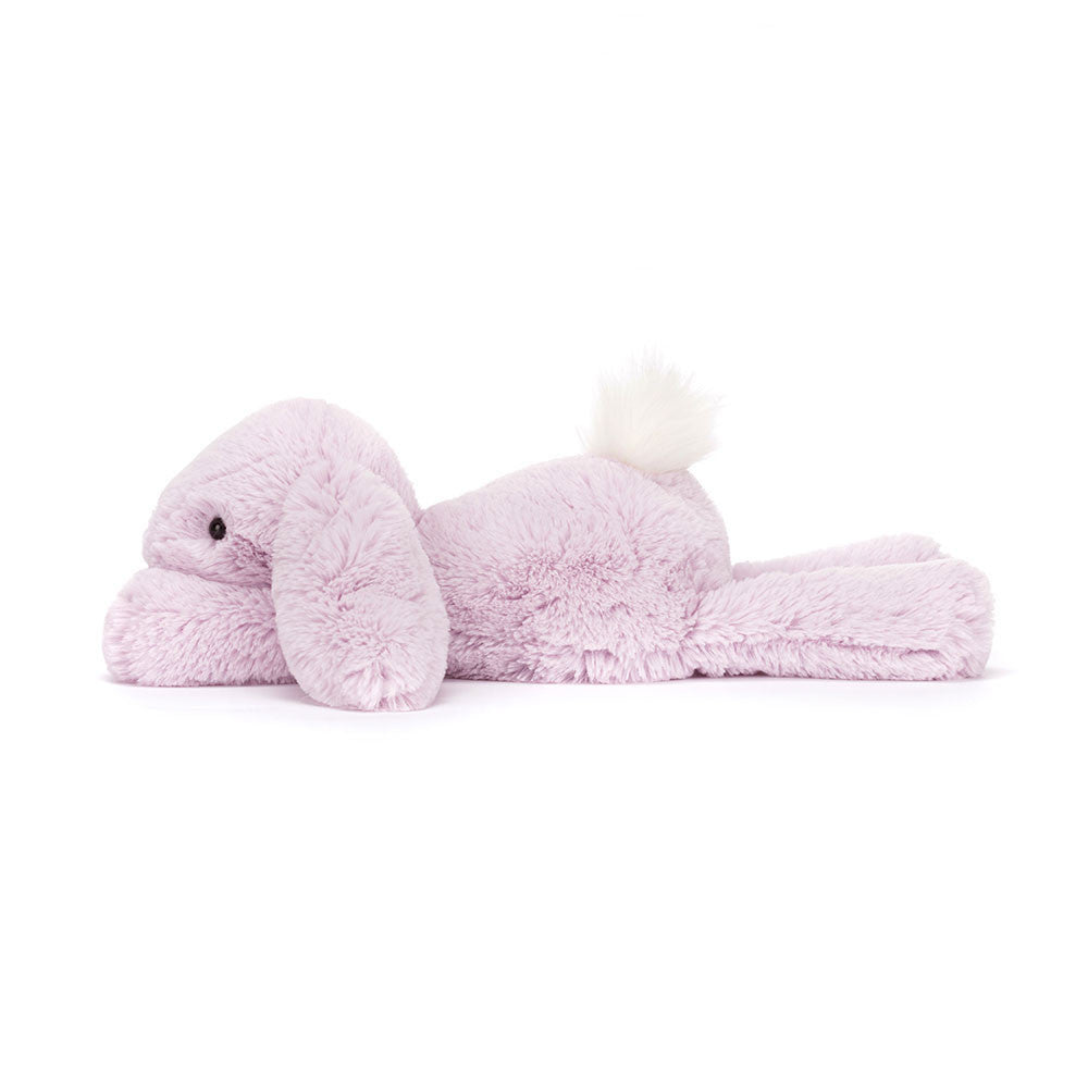 A plush toy resembling a lavender-colored rabbit with a fluffy cream bobtail, soft ears, and black eyes.