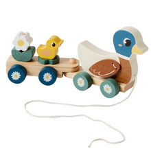 A wooden pull-along Duck Train toy with a blue duck and yellow duckling on top, along with a flower, arranged on two stacking poles with blue wheels and white flowers.