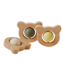 Three wooden infant tea, the toys representing bear heads.