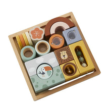 A set of colorful wooden sensory blocks designed for toddlers, featuring different textures and sounds, presented in a wooden storage tray.
