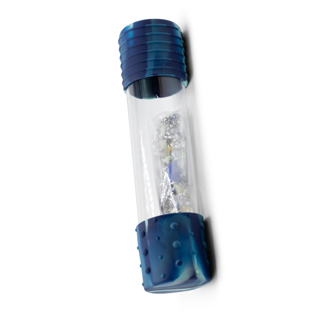 A sensory bottle with blue silicone caps and a clear body containing a mixture of liquids and small objects, designed for sensory play.
