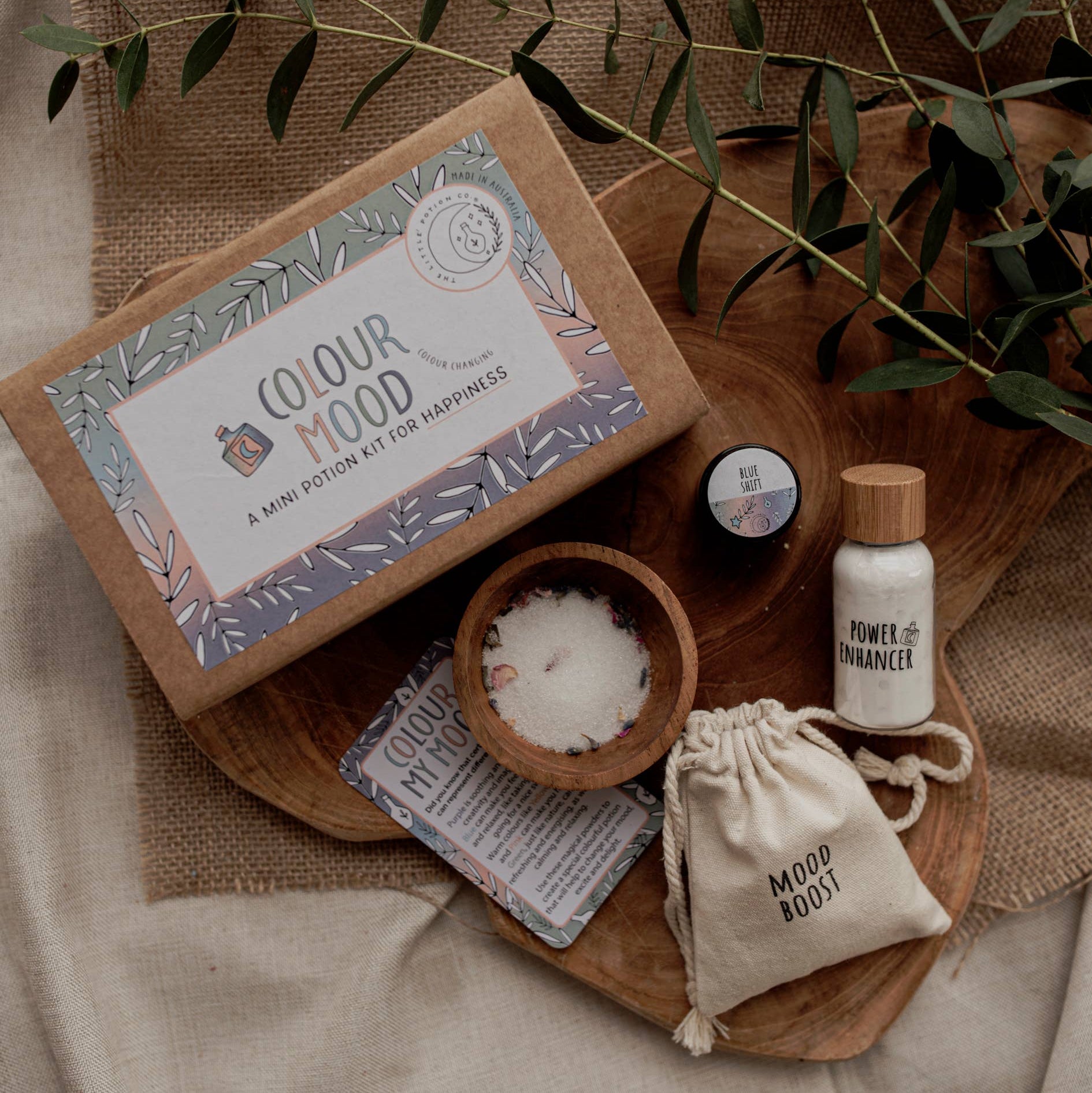 Colour Mood Potion Kit by the Little Potion Co. - contents displayed on wooden tray and hessian cloth
