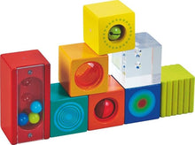 A set of colorful wooden blocks, each with a different sound effect or visual feature designed for toddler learning and play.