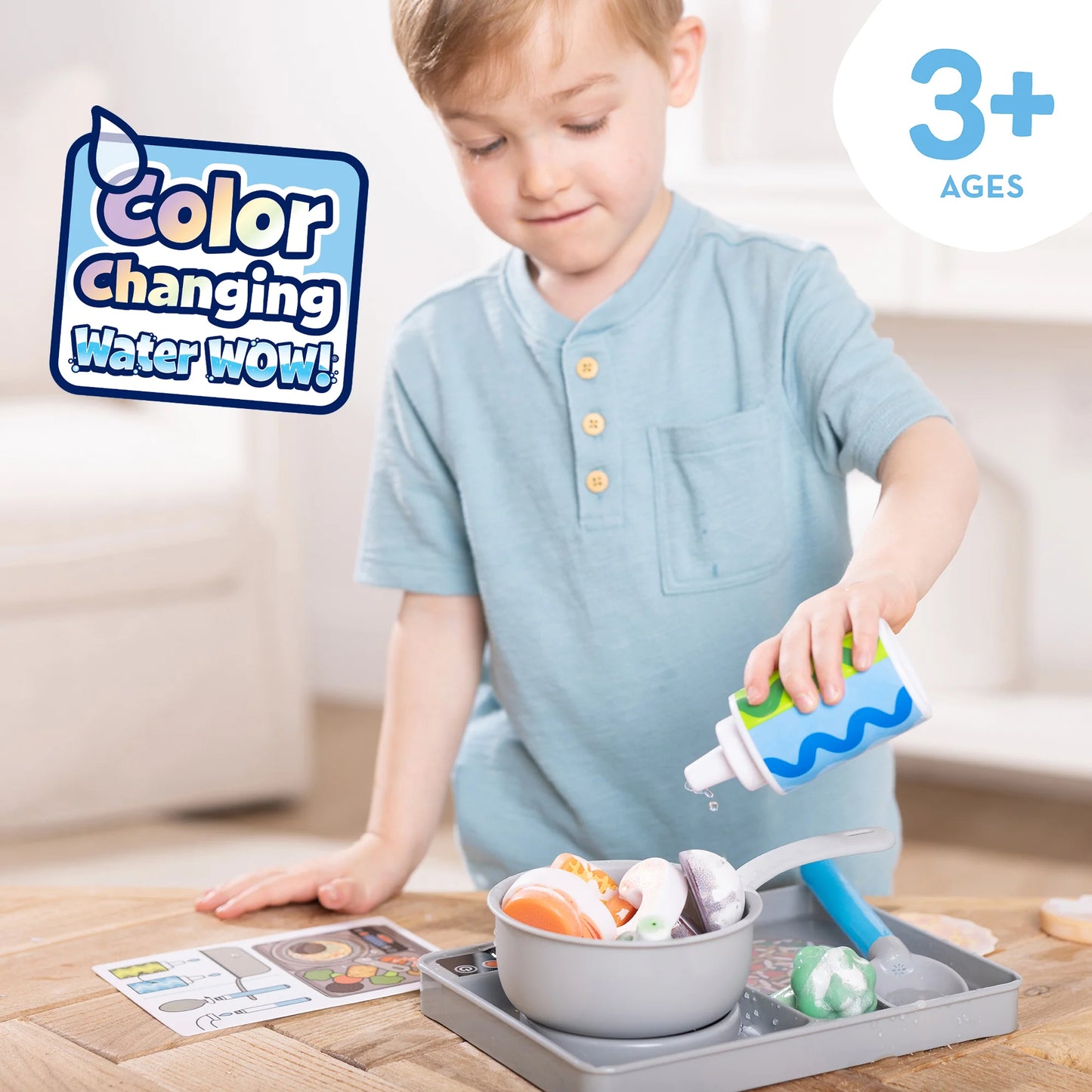 Child playing with a color-changing water toy on a wooden table.