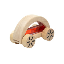 Natural wood car shaped toy with large wooden wheels, filled with light red water suspended behind clear plastic windows
