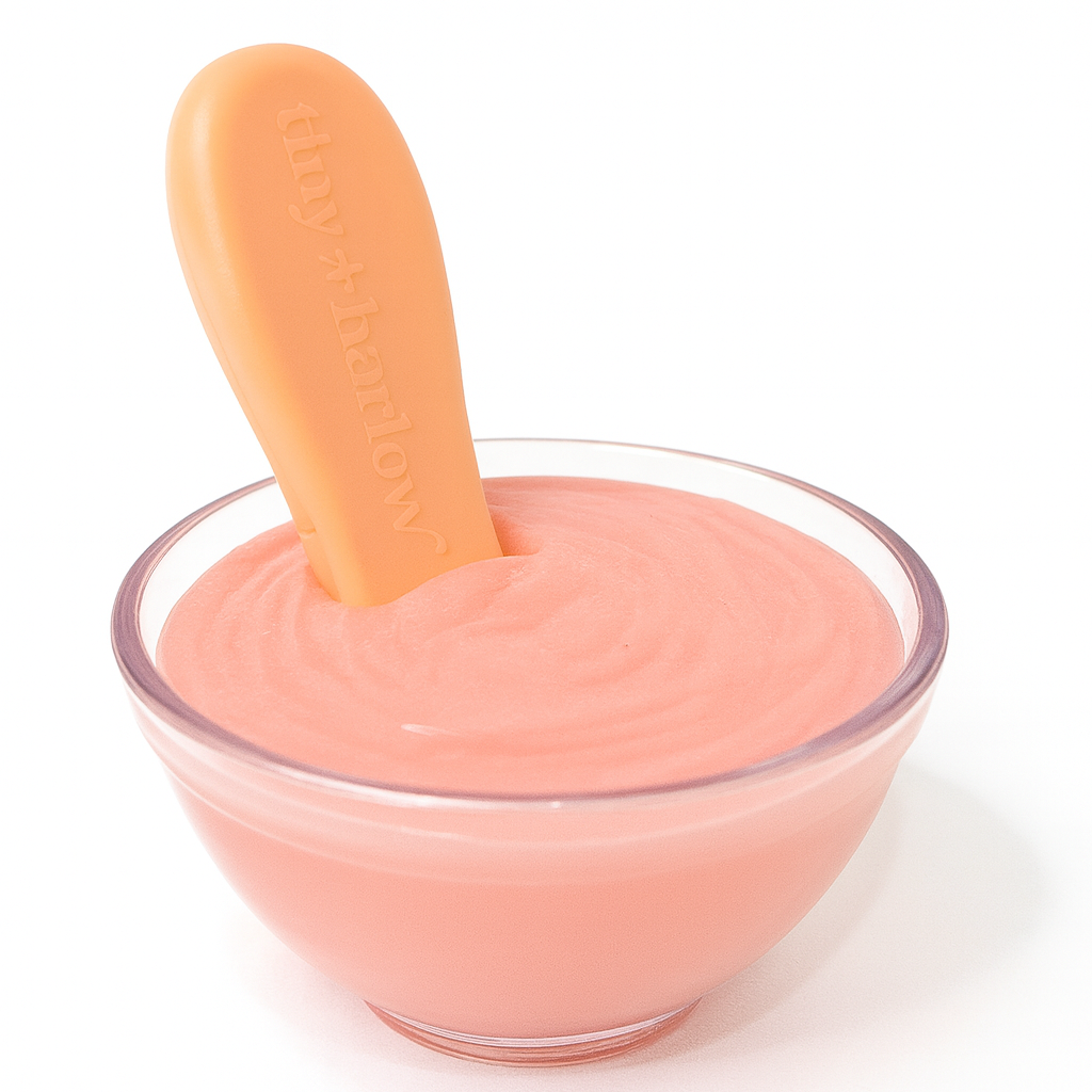 Dolls pretend play food Pink dessert in a clear glass bowl with a pink spoon on a white background