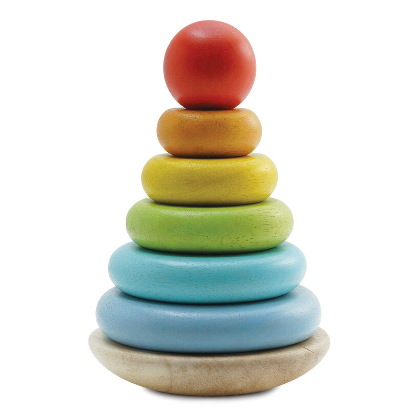 A wooden stacking toy consisting of a wobbly base and six colorful stackable rings in increasing sizes from bottom to top.