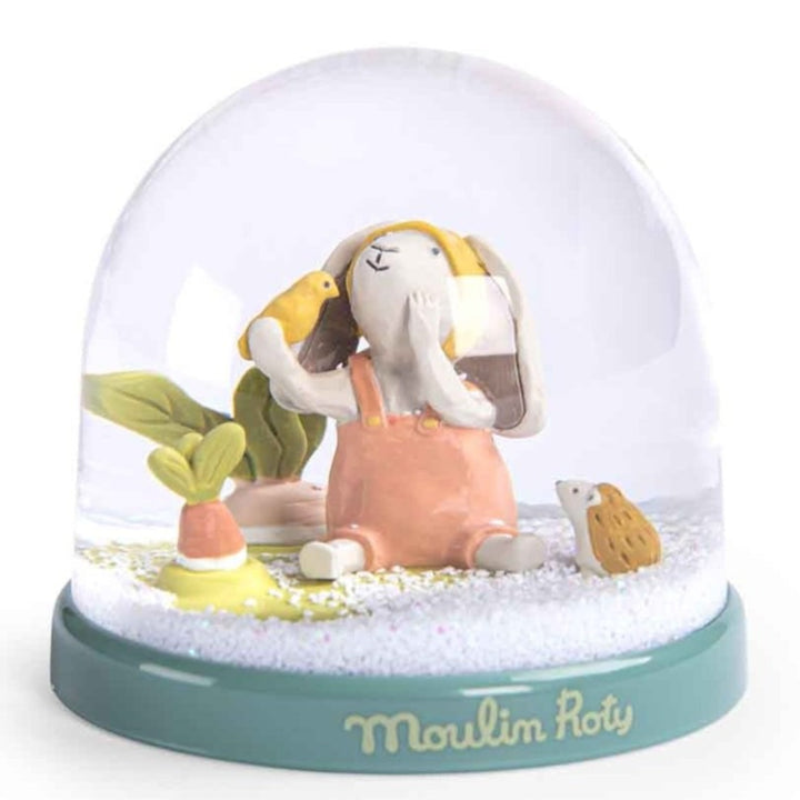 Trois Petits Lapins Snow Globe with resin bunny, hedgehog and yellow bird inside. Moulin Roty brand - retailed online by Send A Toy
