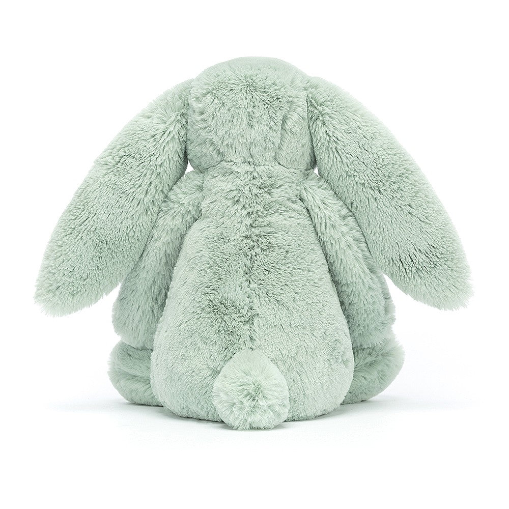 A medium-sized sage green plush toy resembling a rabbit