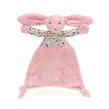A plush toy resembling a tulip pink bunny with a flower-print top, a tulip tummy, and knotted feet, lying flat.