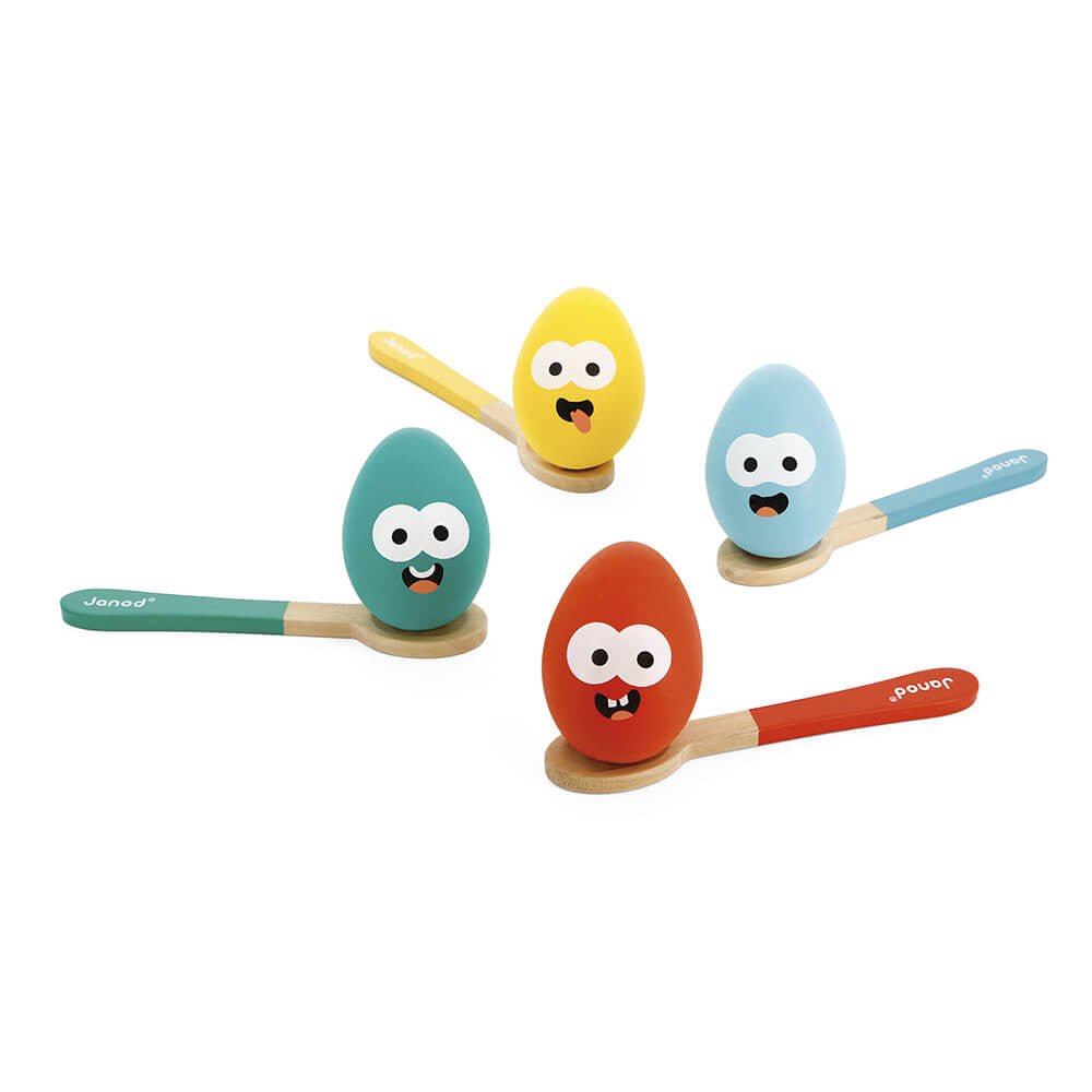 Jade green, yellow, blue and red wooden spoons, each balancing a matching coloured wooden egg with quirky faces.