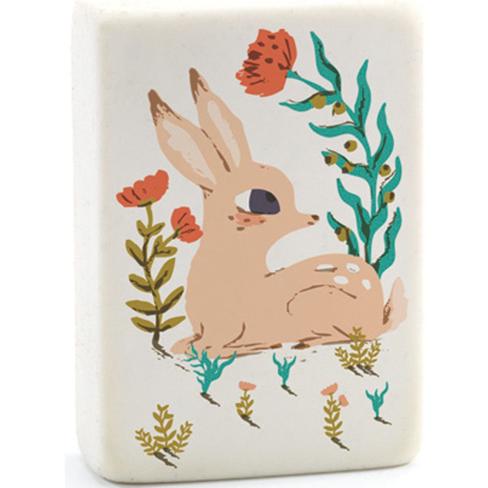 An eraser with an illustration of a fawn surrounded by flowers in shades of pink, red, and green.