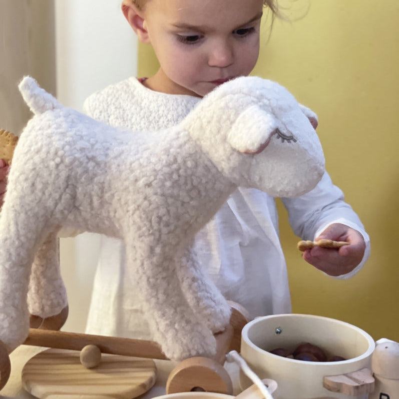 Young girl playing with Egmont Mary Lamb pull-along toy