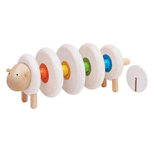 Wooden lacing toy shaped like a sheep, with beige and natural wood colors and lacing holes along its body.