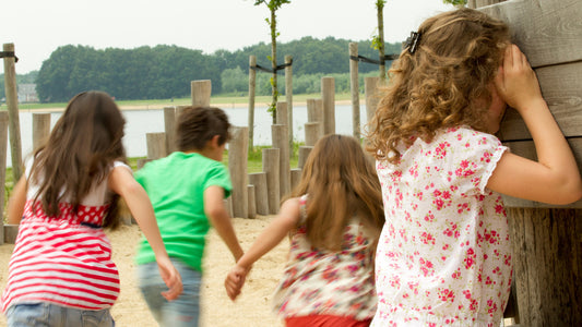 Children playing hide and seek game outside