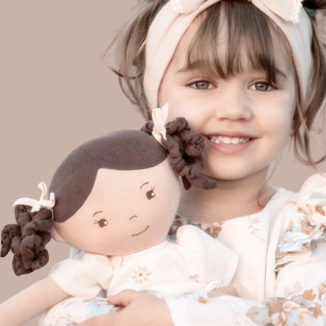 Young girl holding a rag doll - Rag Doll collection at Send A Toy
