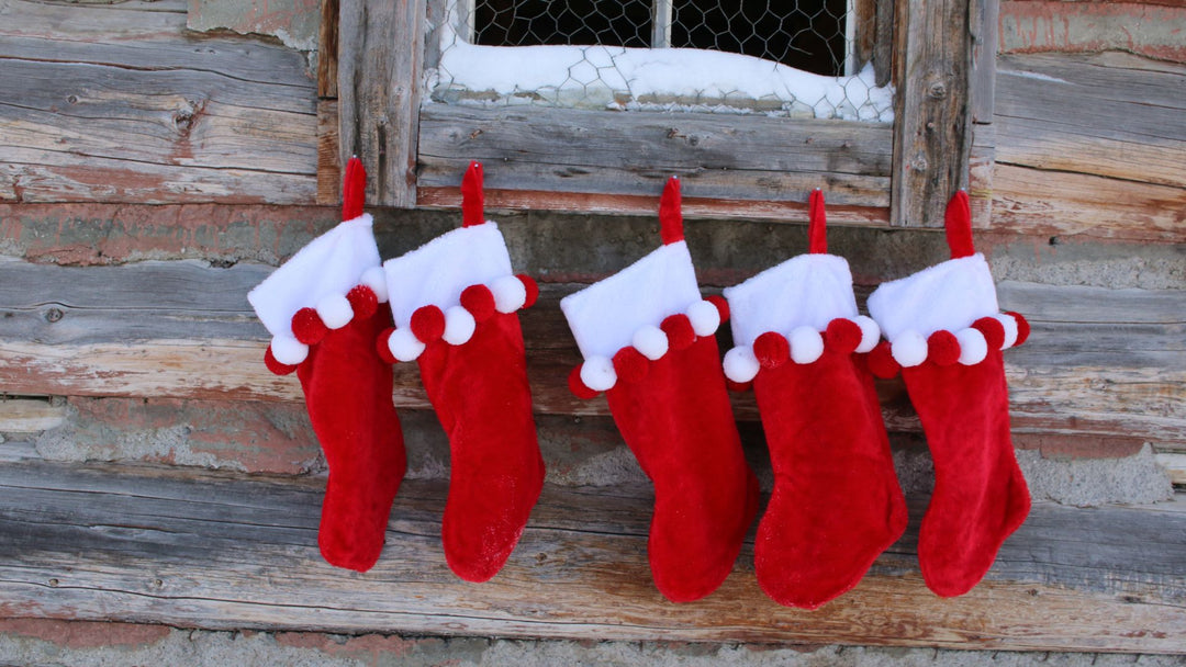 Christmas stockings hanging on window with snow outside