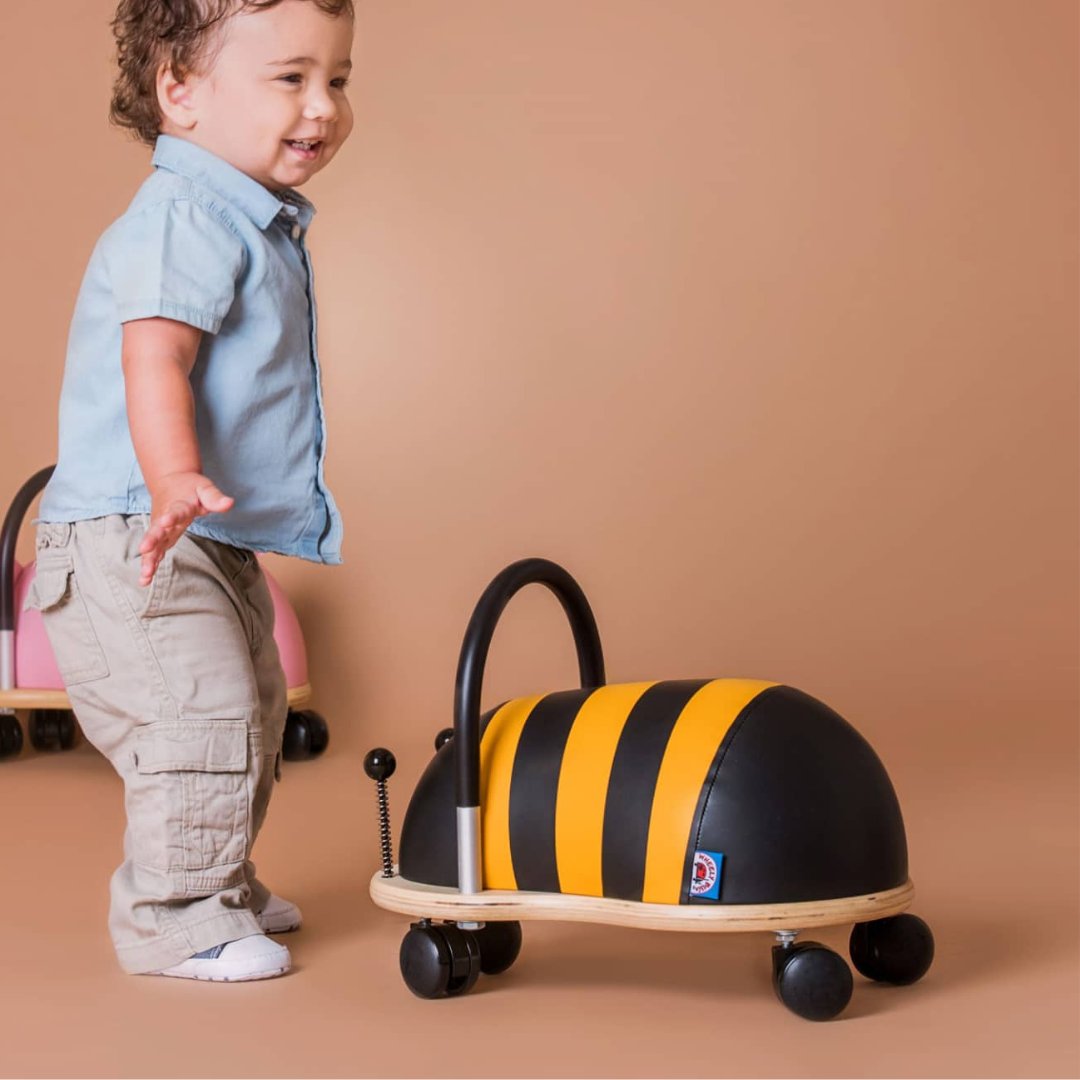 toddler child with Wheely Bug Bee ride-on toy - Ride-On toys collection at Send A Toy