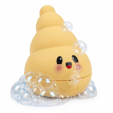 A yellow shell shaped  container with a cute cartoon face and the brand name 'Janod' embossed on the front, set against a plain white background.