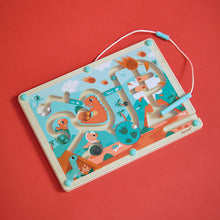 Janod Dino Magnetic Maze at an angle on a red background with the stylus resting on top
