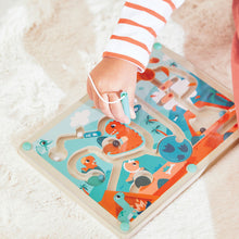 Child guiding a magnetic bead through the Janod Dino Magnetic Maze with the stylus