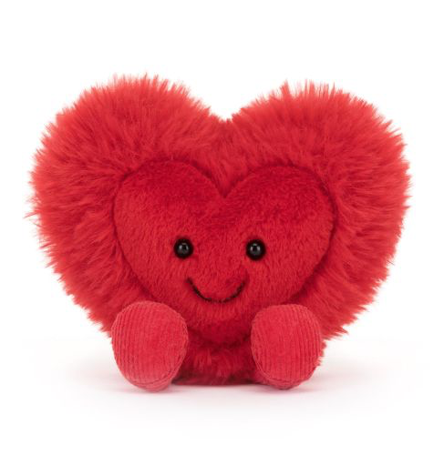 Fluffy red soft toy made by Jellycat in the shape of a heart. The heart has a smiling face and red plush legs.