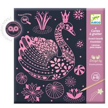 A packaged scratch card game with a pink swan design, labeled as glow-in-the-dark and suitable for ages 6-10.