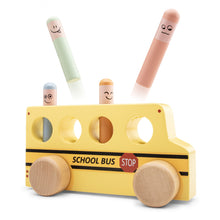 A wooden pop-up school bus toy with figures inside that pop up when pressed, made by New Classic Toys.