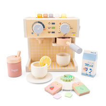 Wooden toy coffee machine set with various accessories including coffee pods, tea bags, sugar jar, lemon slice, and milk jug, displayed alongside two cups with saucers.