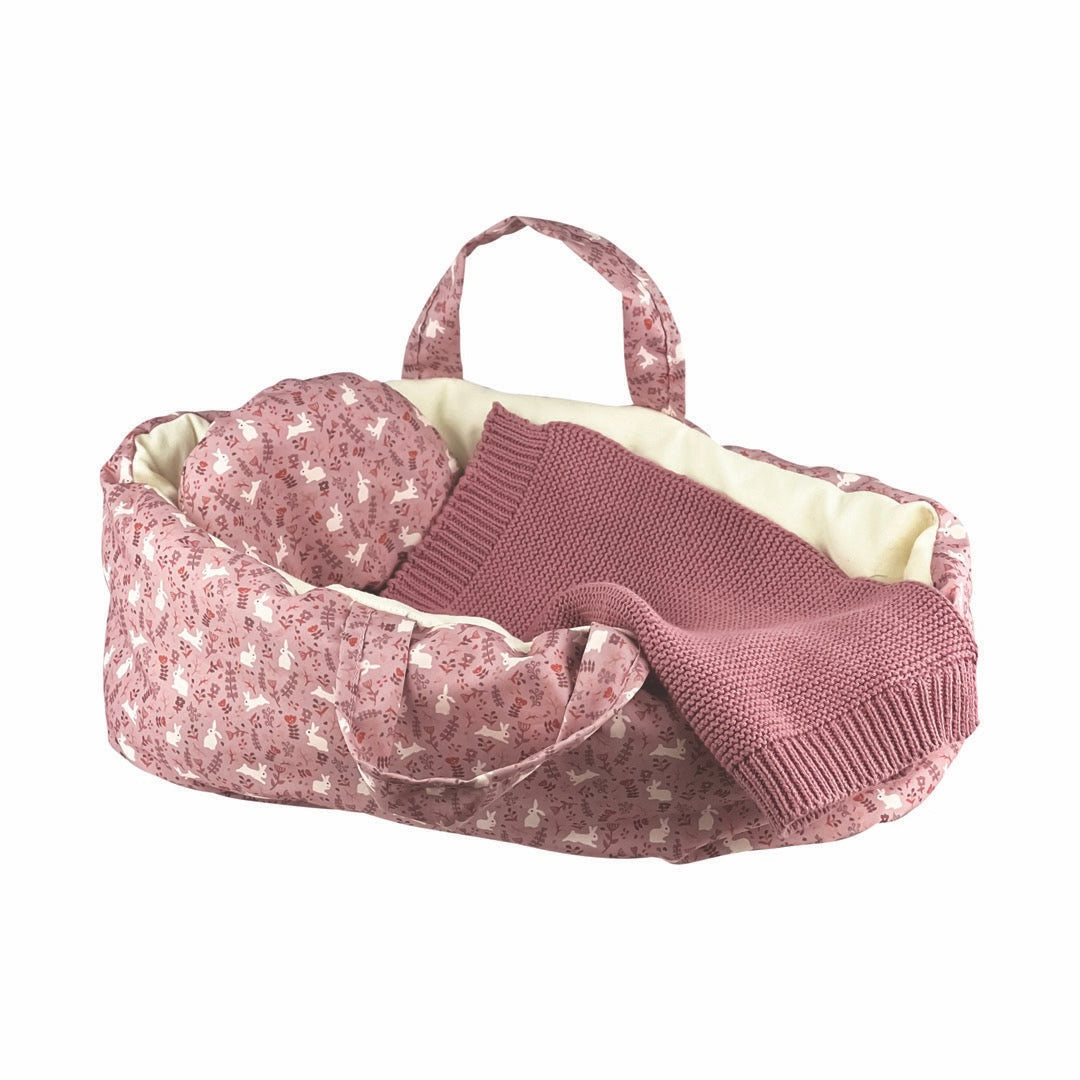Dolls padded fabric carry cot with knitted blanket.
